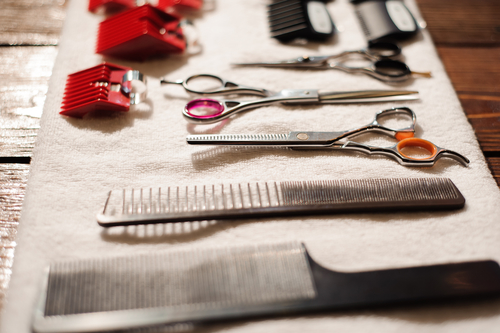 hairdressing tools on a towel - scissors, combs, clipper