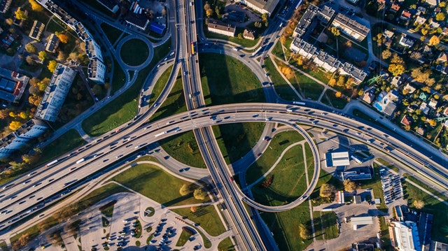 picture of a highway near houses and apartments